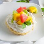 Gluten Free Lemon Fruit Flan on a plate with mango and melon