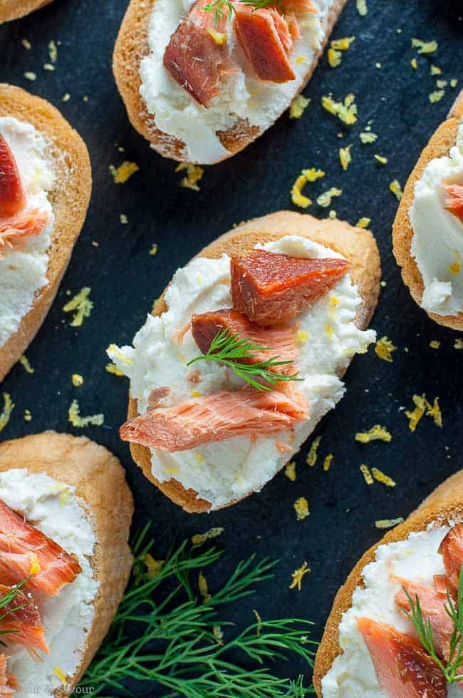 Smoked Salmon Crostini with Whipped Honey Lemon Goat Cheese on a slate tray