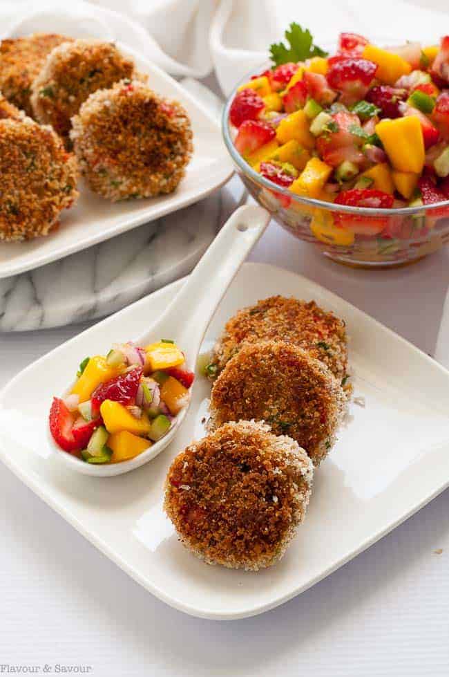 Tex-Mex Crab Cakes on a plate with a bowl of Strawberry Mango Salsa 