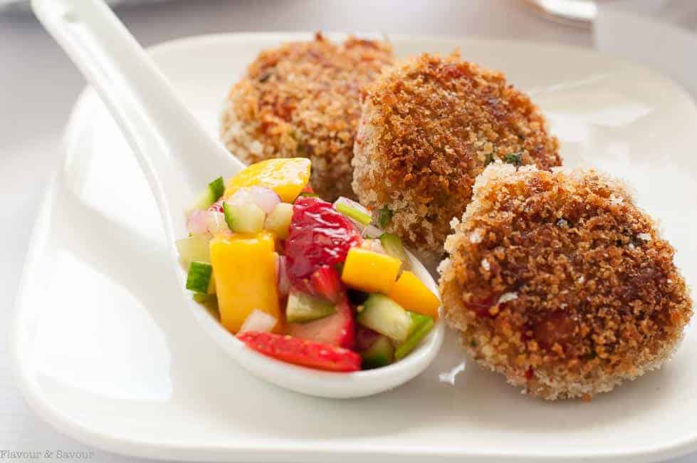 Tex-Mex Crab Cakes with Strawberry Mango Salsa on a white plate with a spoonful of colourful mango salsa