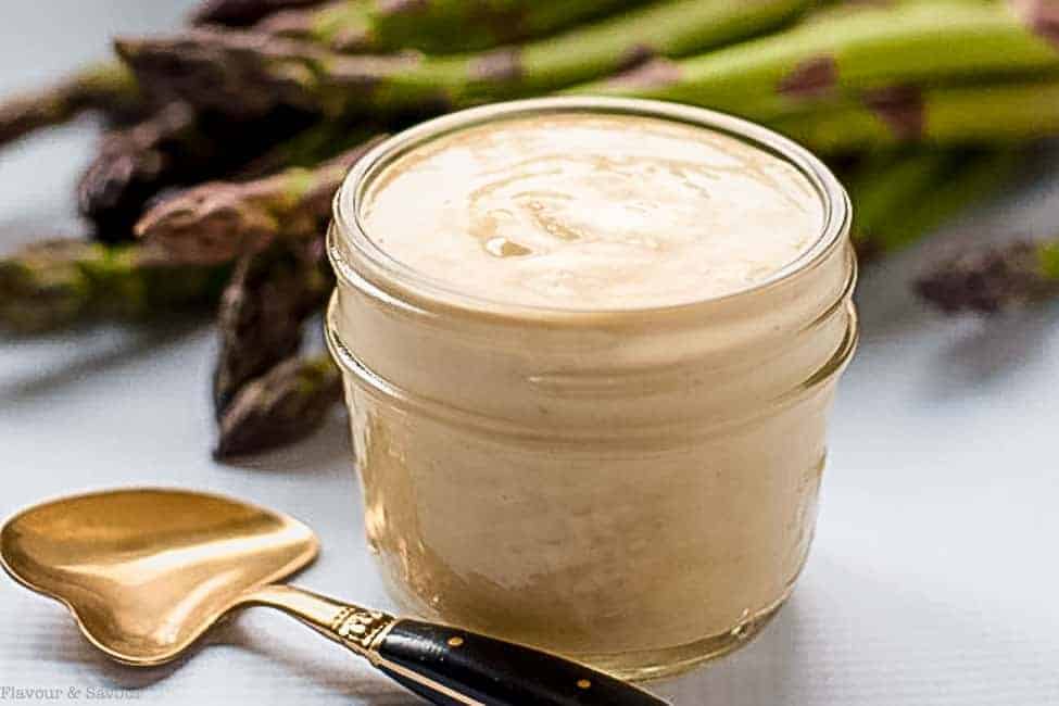 Simple Lemon Tahini Sauce in a small Mason jar with a spoon.