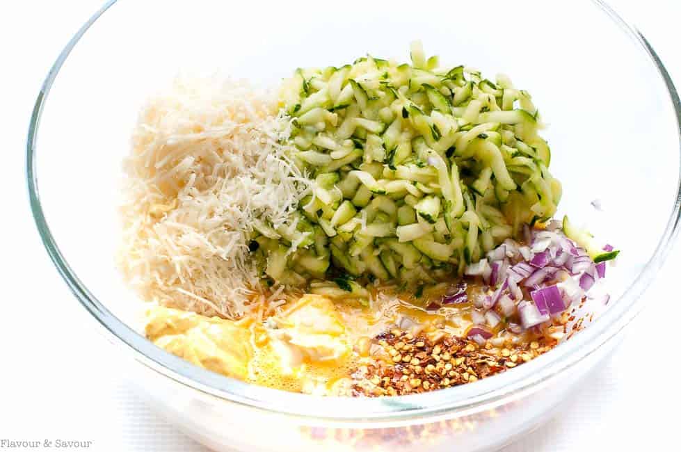 Ingredients for Crispy Baked Zucchini Patties in a bowl.