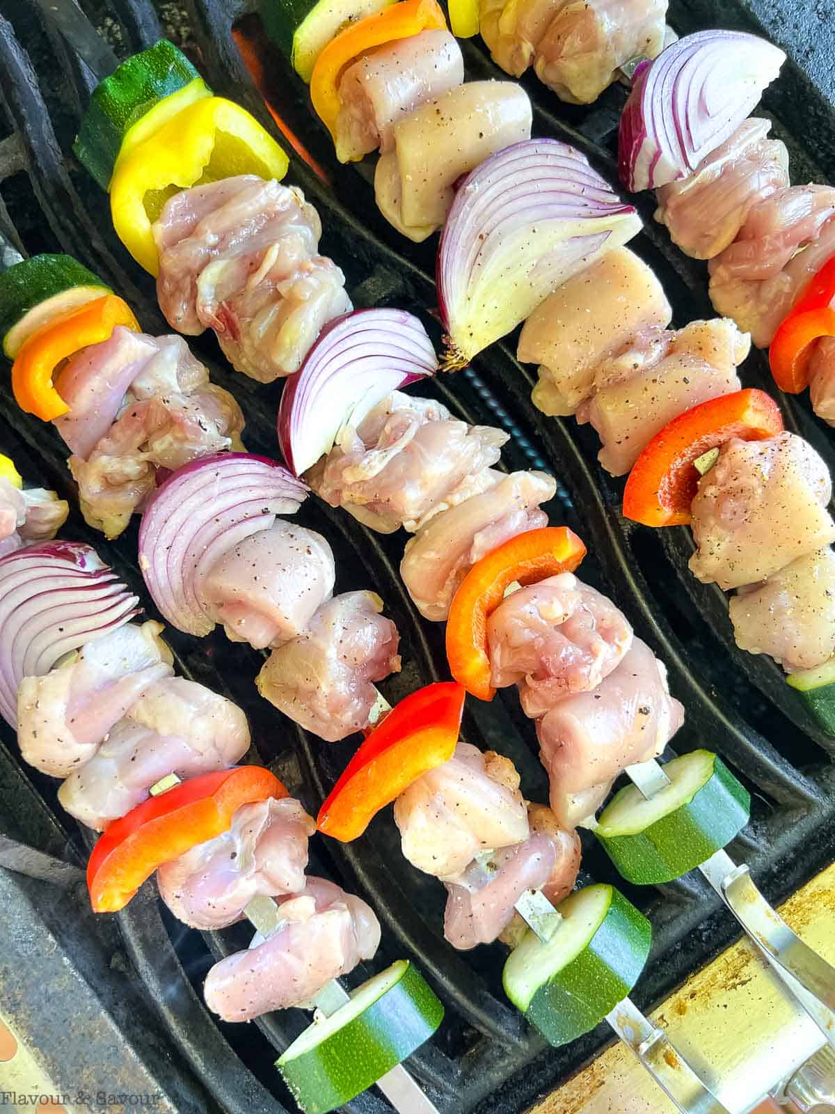 rosemary mustard chicken kabobs on a grill.