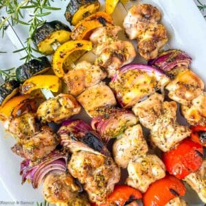 Grilled rosemary mustard chicken kabobs on skewers.