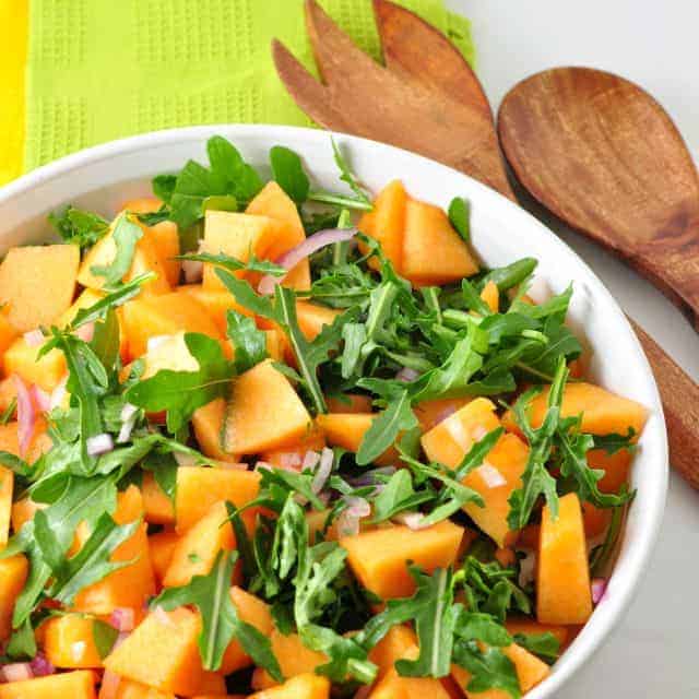 Cantaloupe Arugula Salad with arugula leaves and red onion