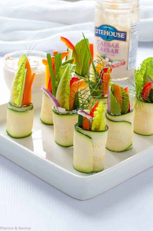  Fresh Veggie Zucchini Roll-Ups on a serving tray with Litehouse Caesar dressing as a dip.
