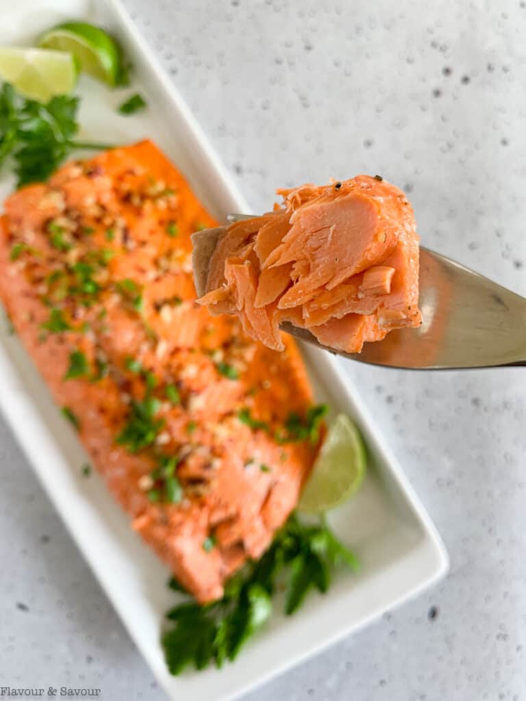 A forkful of baked salmon.