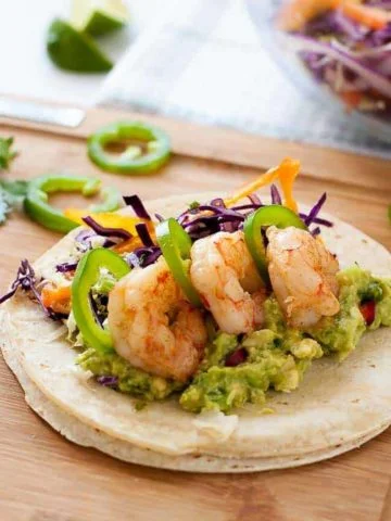 Shrimp Tacos with zesty Tomatillo Guacamole and Cilantro Lime Slaw.