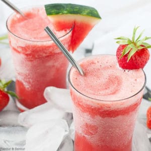 Two glasses of Strawberry Watermelon Sangria Slushie with straws