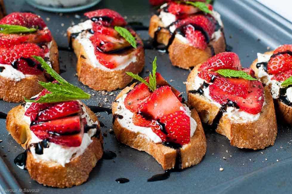 Strawberry Whipped Feta Crostini with Balsamic Drizzle on a baking sheet |www.flavourandsavour.com