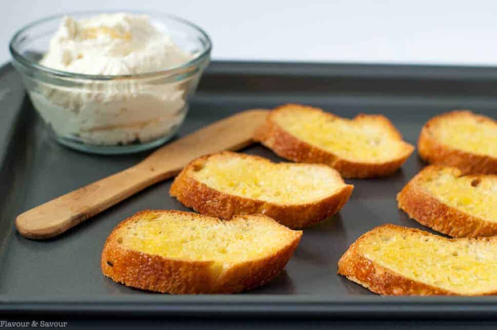 Toasted Crostini on a baking sheet for Strawberry Whipped Feta Crostini with Balsamic Drizzle |www.flavourandsavour.com