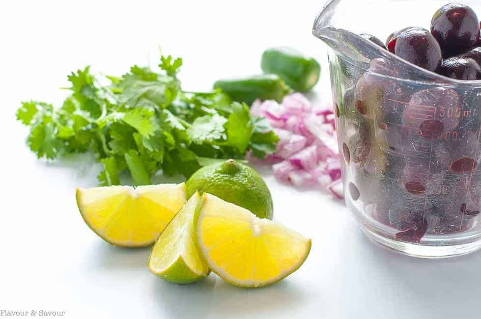 Fresh cherries, lime, jalapeno, red onion an cilantro for fresh cherry salsa