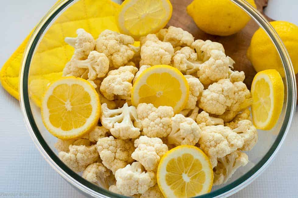 Cauliflower florets and lemon slices in a bowl ready to make Cauliflower Lemon Basil Salad 