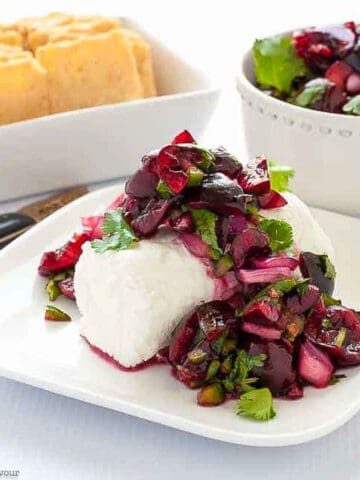 fresh cherry salsa on a log of goat cheese