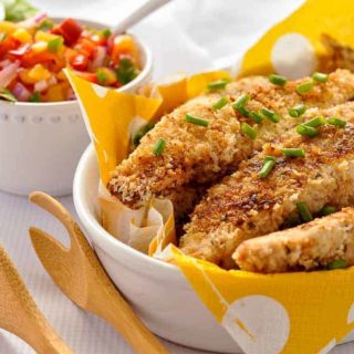 Cajun Chicken Strips in an oval bowl with a yellow napkin