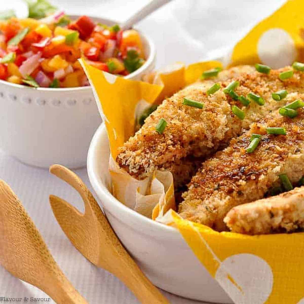 Crispy chicken tenders with a bowl of nectarine salsa.