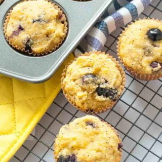 Paleo Blueberry Lemon Poppy Seed Muffins cooling on a rack.