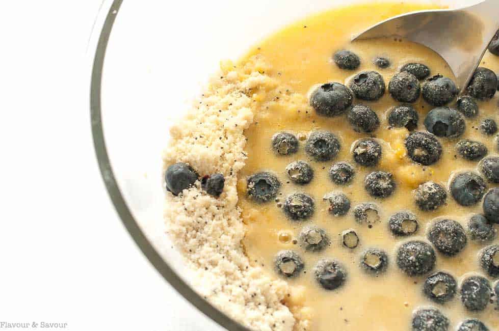 Ingredients for Paleo Blueberry Lemon Poppy Seed Muffins in a mixing bowl.