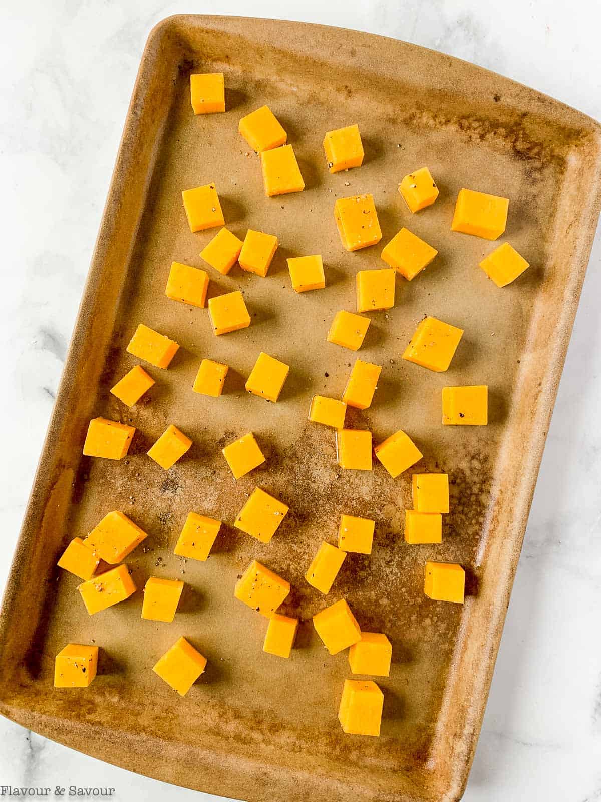 Butternut squash on a baking sheet.