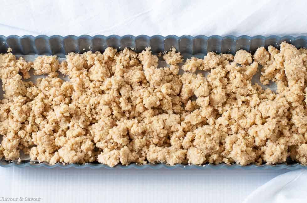 Gluten Free Sour Cherry Almond Tart pastry in a pan with a removable bottom, ready to be pressed into place.