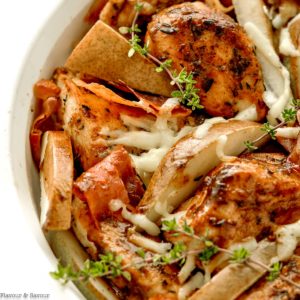 Close up view of a dish of chicken with prosciutto and pears
