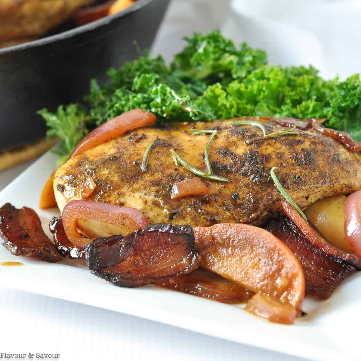 Close up view of a chicken breast with bacon and apples