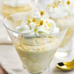 pumpkin cheesecake mousse topped with whipped cream in a dessert glass