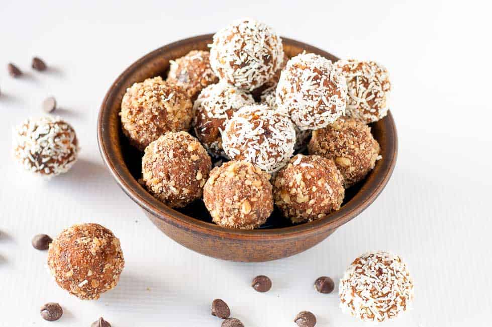 Grain-Free Peanut Butter Chocolate Pumpkin Energy Balls in a brown stoneware bowl.