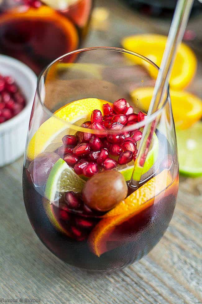 Pomegranate Red Wine Sangria in a glass with citrus fruit slices and pomegranate arils