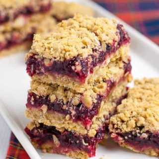 a stack of Cranberry Lemon Oat Bars on a plaid cloth