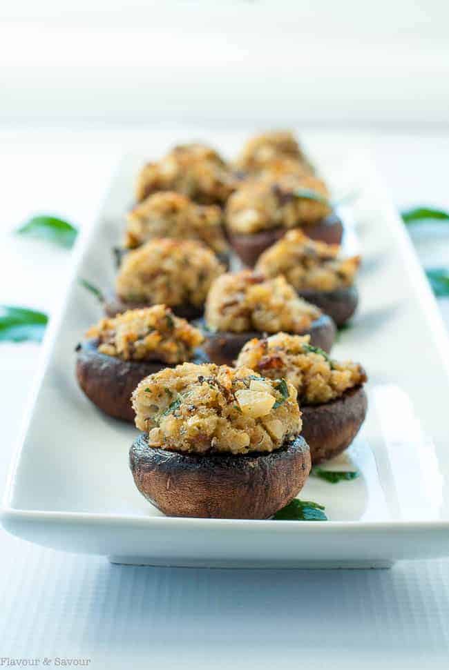 Garlic Lovers' Blue Cheese Stuffed Mushrooms lined up on a white rectangular serving dish.