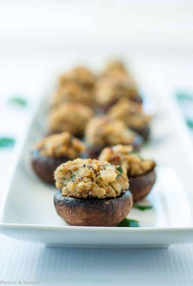 Close up view of Blue Cheese Stuffed Mushrooms on a white platter.