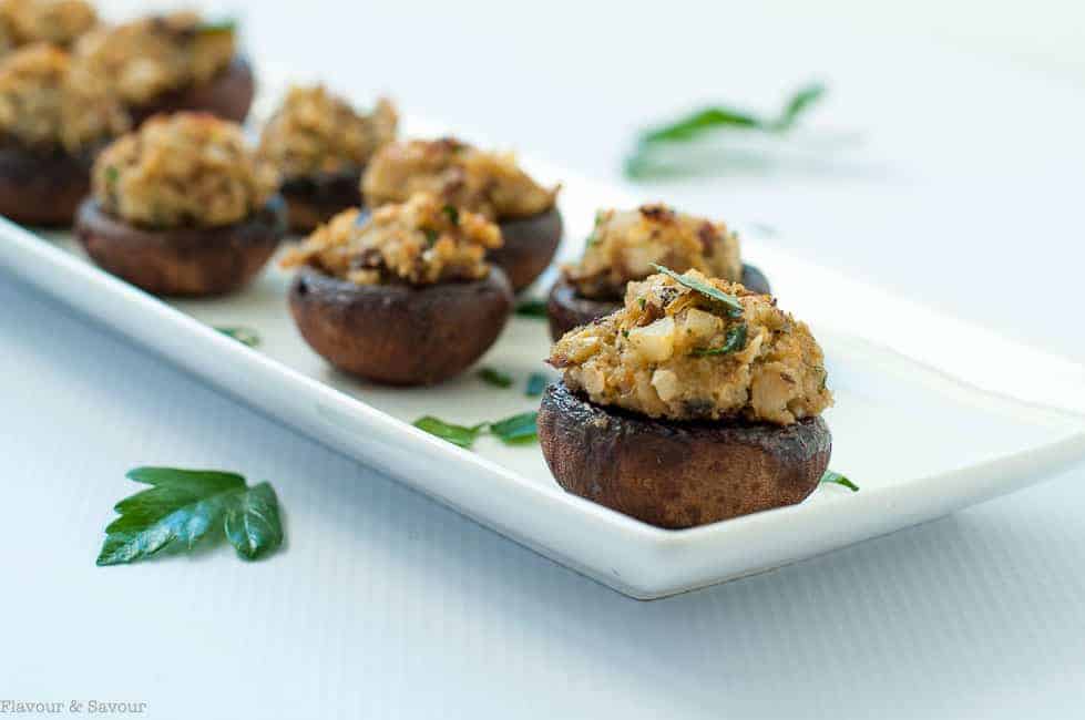 Garlic Lovers' Blue Cheese Stuffed Mushrooms in a row on a white serving dish