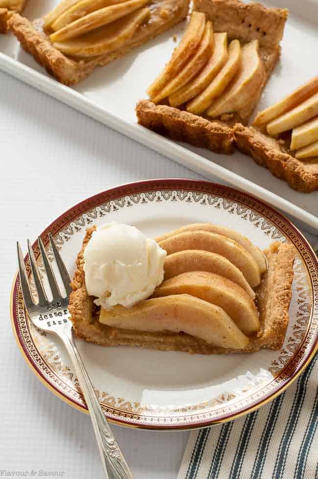 Overhead view of a serving of Gluten Free Cinnamon Pear Tart with a scoop of ice cream