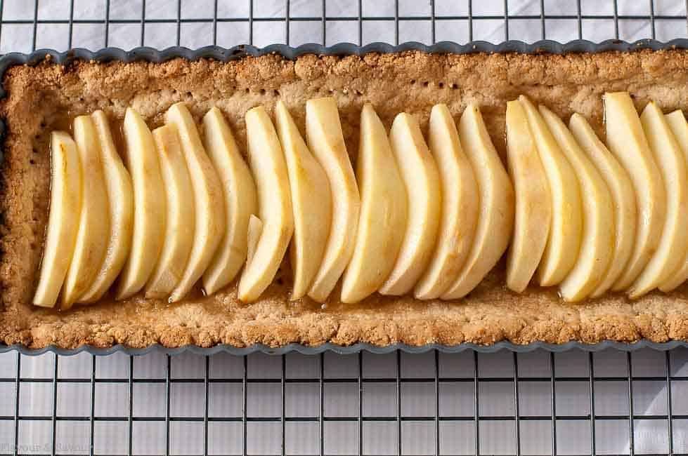 pears lined up in baked tart in oblong tart pan