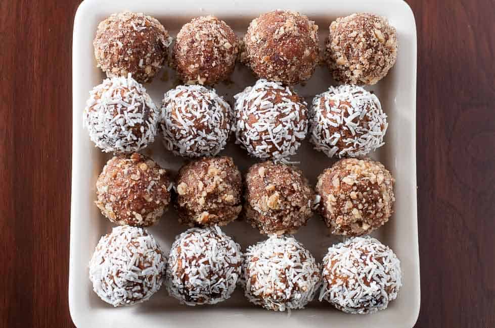 Chocolate Pumpkin Energy Balls lined up on a plate.
