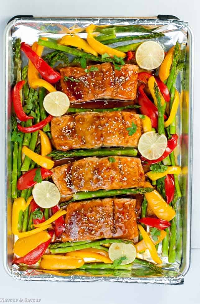 Thai Chili Sheet Pan Salmon on a sheet pan with asparagus and bell peppers.