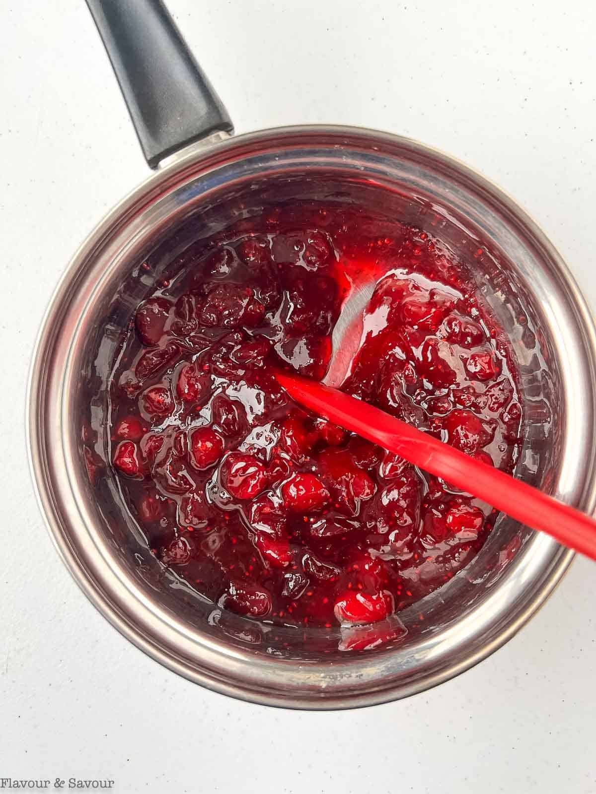 Cranberry filling for cranberry lemon oatmeal bars in a saucepan.