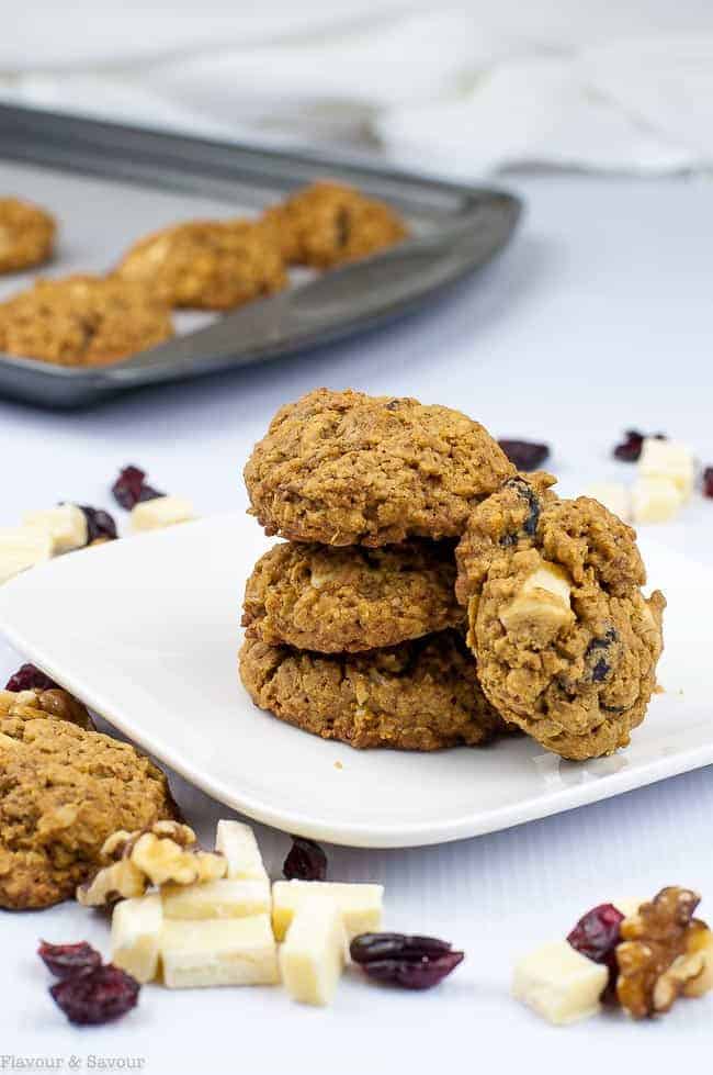 Cranberry Pecan White Chocolate Oatmeal Cookies stacked on a plate.