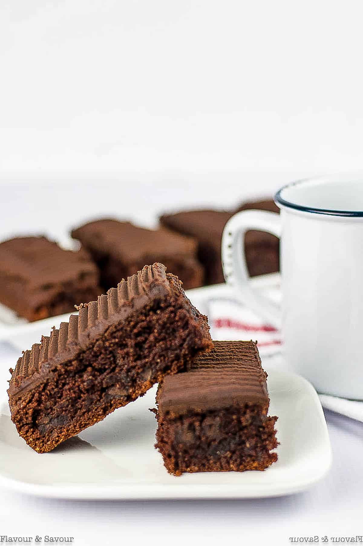 Two bars of Amaretto Brownies on a plate.