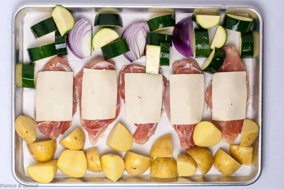 Preparing Chicken and Vegetables for Prosciutto and Cheesy Chicken Sheet Pan Dinner