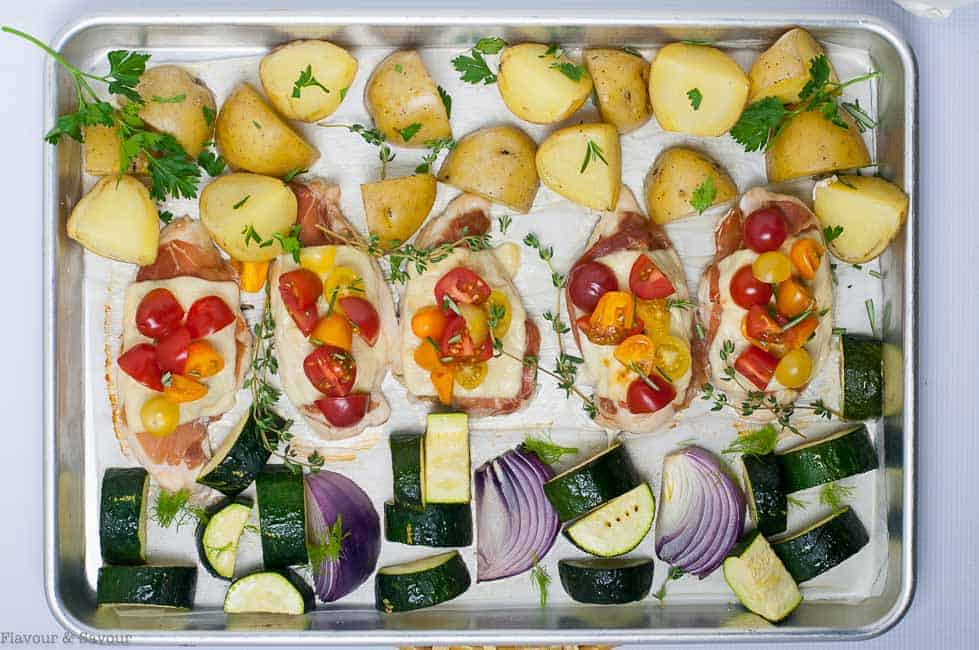 Horizontal overhead view of baked Prosciutto and Cheesy Chicken Sheet Pan Dinner