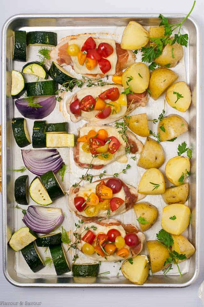 Baked Prosciutto and Cheesy Chicken Sheet Pan Dinner. Overhead view on a sheet pan.