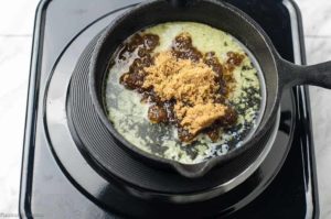 adding butter and sugar to Caribbean Rum Bananas Flambé with Amaretto