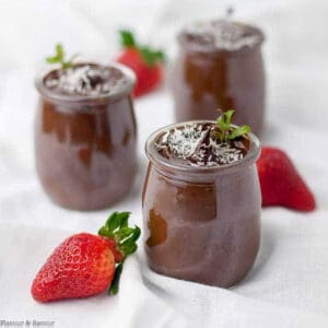 3 small dessert glasses with dairy-free vegan chocolate mousse with fresh strawberries