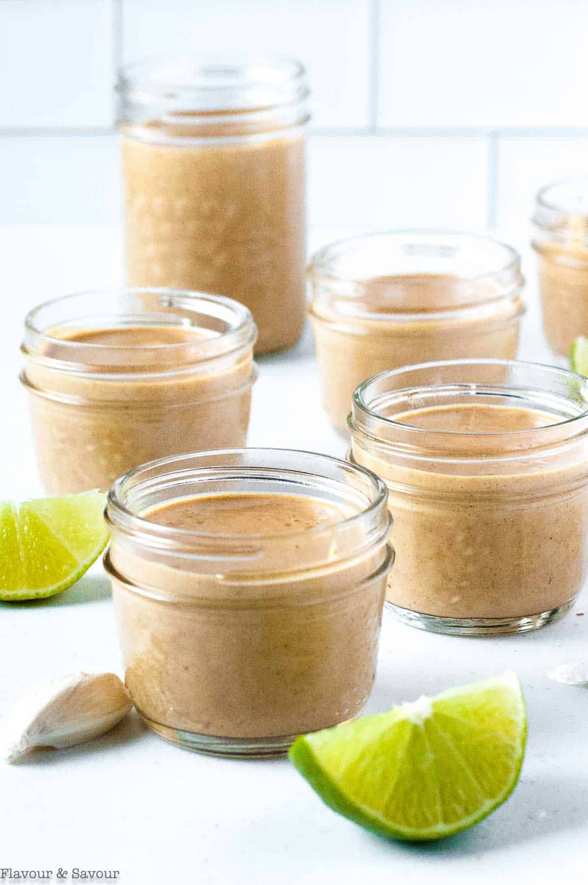 jars of peanut sauce with lime slices