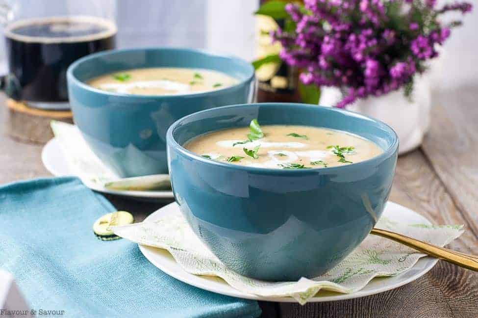 Creamy Roasted Garlic Irish Potato Soup in blue bowls