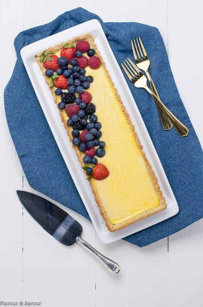 Gluten-Free Lemon Curd Tart in rectangular tart pan on blue napkin