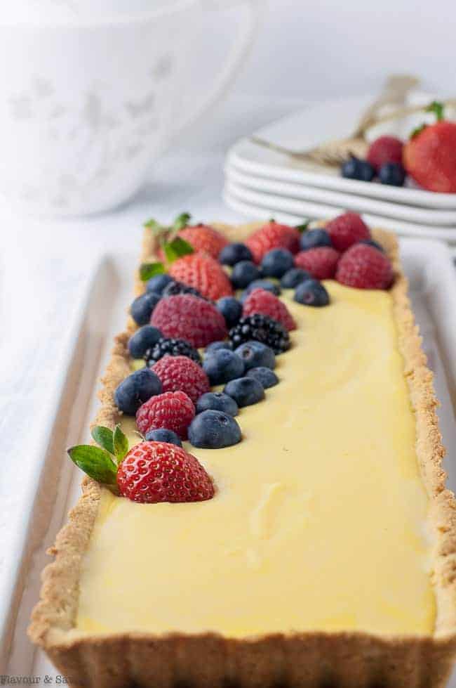 Gluten-Free Lemon Curd Tart with mixed berries close up view