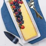 Gluten-Free Lemon Curd Tart with Berries and Almond Flour Crust on blue napkin
